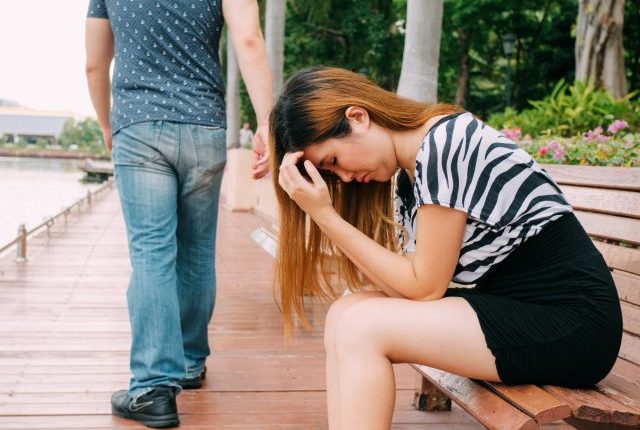 man walking away from woman with broken =heart