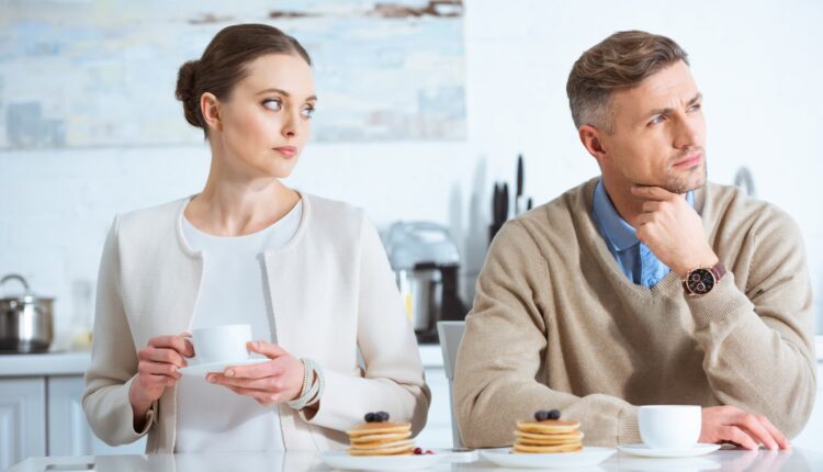 gorgeous woman looking at her gorgeous man who is thinking